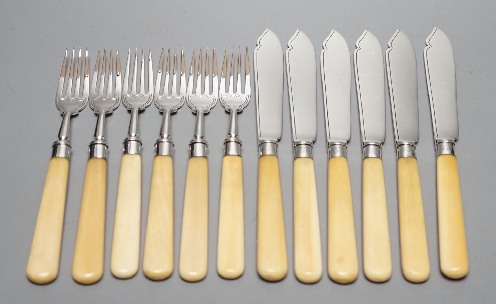 Six pairs of George V ivory handled silver fish eaters, Goldsmiths & Silversmiths Co Ltd, Sheffield, 1926, knife 21cm.